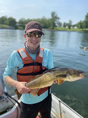 jackson booth on a boat holding a fish